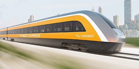 Imagen de un trenvia amarillo, gris y blanco en movimiento
