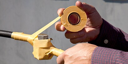 An image illustrating wrapping of a connector on a Low-Voltage cable with Scotch® 2510 Varnish Cambric Tape
