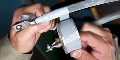 An image illustrating wrapping of a low-voltage motor lead connection with Scotch® Self-Fusing Silicone Rubber Tape 70
