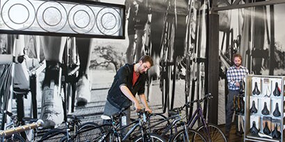 Man standing in front of a wall wrapped in 3M Opaque printable film.
