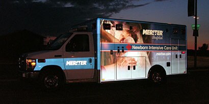 Intensive Care Unit vehicle wrapped in 3M reflective film, shining at night.
