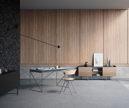 Interior de una habitación minimalista y moderna con paredes acabadas en mármol negro, concreto y madera media con acabados arquitectónicos DI-NOC de 3M.
