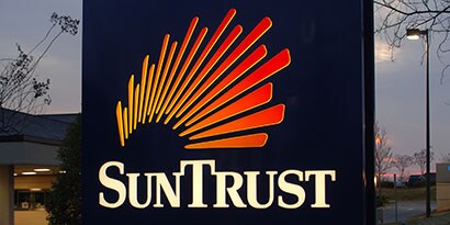 Illuminated SunTrust Sign wrapped in a red and orange colored 3M translucent film.
