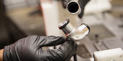 Learn about material bonding. Image of metal pipe bonding with liquid adhesives.
