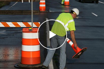 Workman on highway at night
