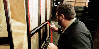 Image of a person applying VHB tape to a traler panel.
