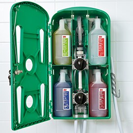 A 3M chemical dispensing system displaying four bottles of chemicals loaded and ready for use.