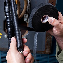 Image showing application of EMD Linered Rubber Splicing Tape 23 to motor lead cable