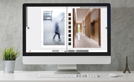 Monitor de computadora de escritorio con imagen de un catálogo interactivo que muestra páginas con acabados de cristal y superficies.
