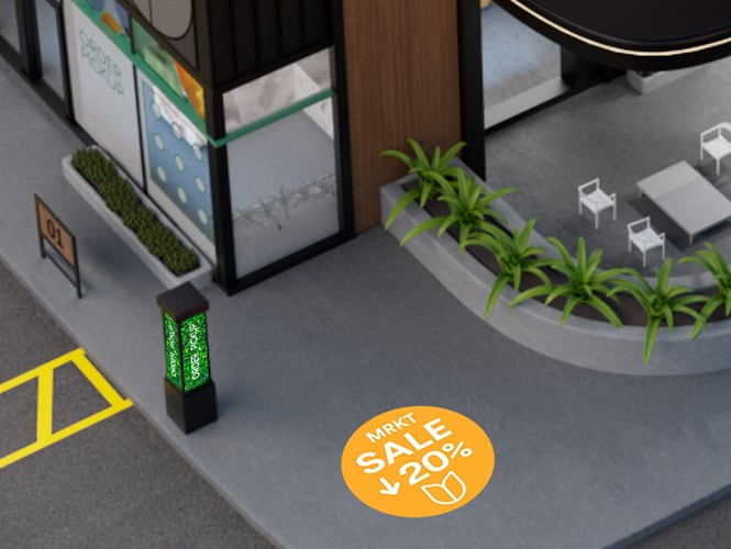 Vista aérea de un estacionamiento con espacios demarcados, incluyendo estacionamiento accesible, adyacente a un edificio con mesas al aire libre.
